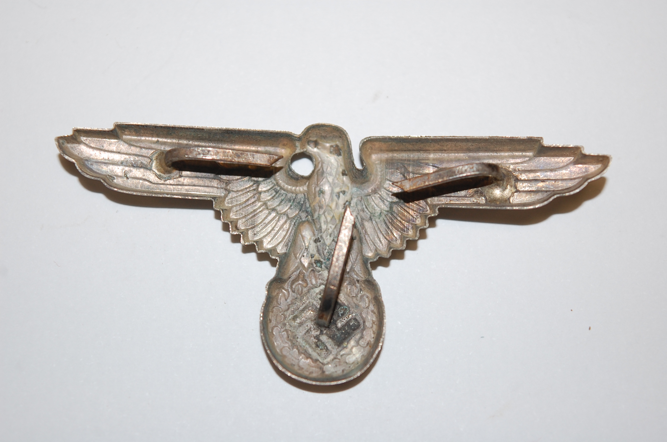 A German Waffen SS spread eagle cap badge, together with three others. - Image 2 of 5