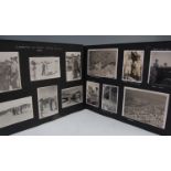 An album of WW II photographs with hand written annotation to the opening page C.R.N. Holloway R.A.