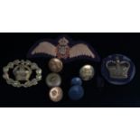 A small collection of military badges and buttons to include R.A.F. etc.
