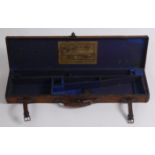 An early 20th century canvas covered and leather bound gun case,
