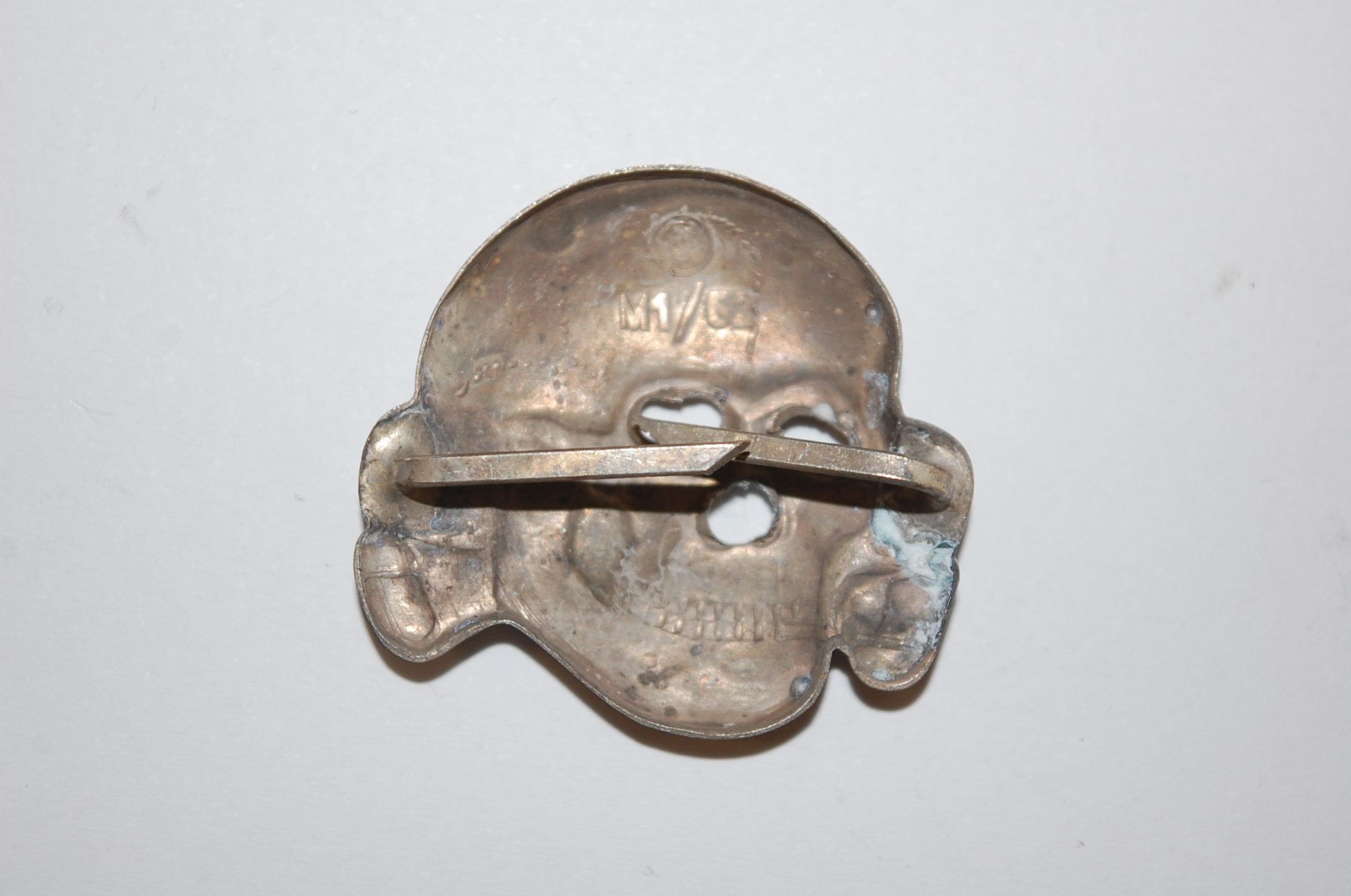 A German Waffen SS spread eagle cap badge, together with three others. - Image 3 of 5