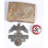 A German Nazi party enamelled badge, together with a Blut und Boden badge and a German belt buckle.