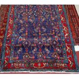 A Persian woollen blue ground rug,