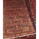 A Persian woollen runner, having ornate geometric field within multiple trailing borders,