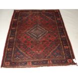 A Persian woollen rug,