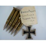 A clip of inert Imperial German rifle rounds with affixed label bearing the annotation German