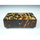 A 19th Century tortoiseshell sewing casket, of rectangular shape with subtly domed lid and bun feet,