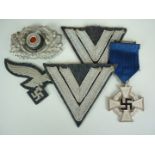 A group of German Third Reich medals and insignia comprising a second class Faithful Service