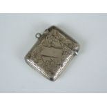 A Edward VII silver vesta case, having bright-cut foliate decoration and vacant cartouche,