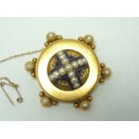 A substantial Victorian Etruscan Revival diamond and pearl locket brooch, of boss form in precious