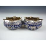 A pair of late 19th / early 20th Century blue enamelled white metal salts, each of wavy-edged oblate
