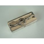 A small silver lidded box, of oblong shape with hinged cover, the latter surmounted by a riding whip