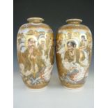 A large pair of Meiji Japanese Satsuma earthenware vases, each of elongated ovoid form and decorated