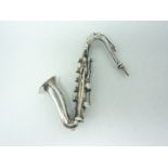 A late 20th Century novelty silver brooch in the form of a saxophone, London import marks