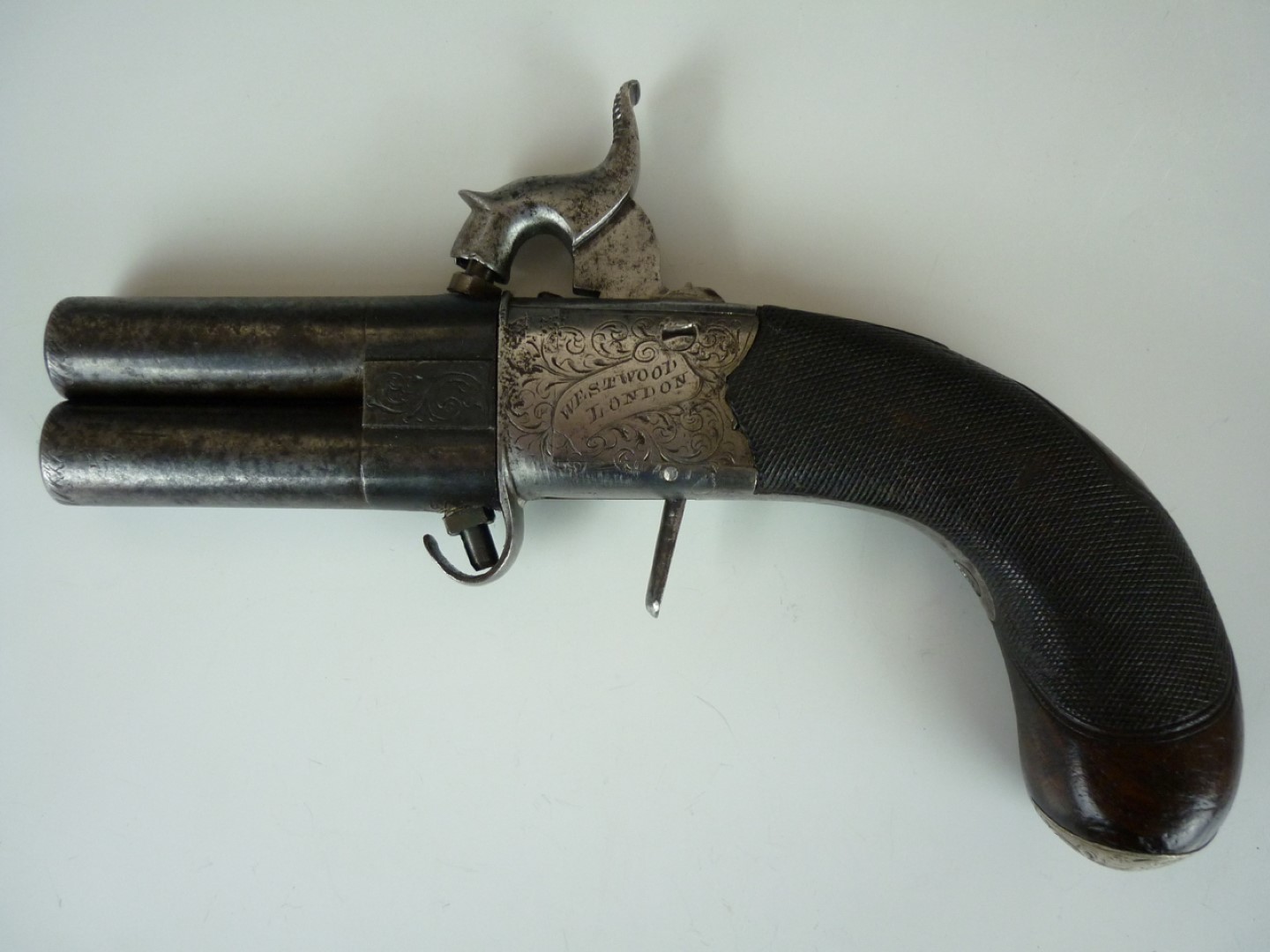 A late Georgian pocket percussion double-barrelled turn-over pistol by Joseph Westwood, having 2 1/