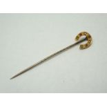 A Victorian 15ct gold stick pin, the terminal modelled as a horseshoe and gypsy set with alternating