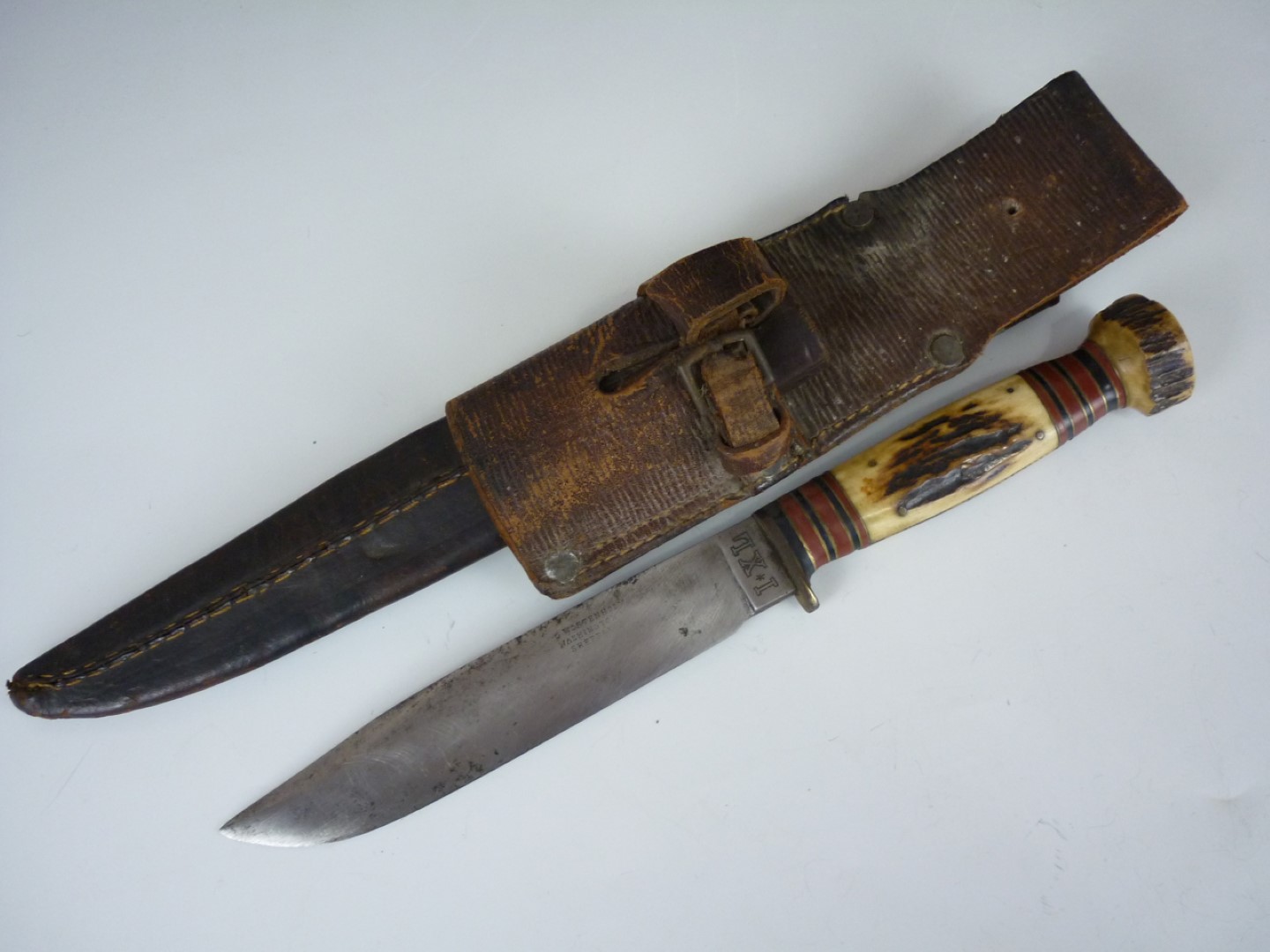 A hunting knife by G Wostenholm of Sheffield, in leather scabbard with Pattern 1914 bayonet frog