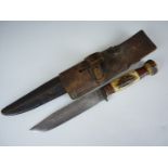 A hunting knife by G Wostenholm of Sheffield, in leather scabbard with Pattern 1914 bayonet frog