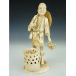 A Meiji Japanese sectional ivory okimono modelled as gardener standing beside a basket of fruit,