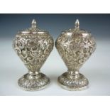 A pair of late 19th / early 20th Century Indian white metal pepperettes, each of pronounced inverted