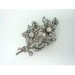 An impressive diamond floral brooch, modelled as a ribbon-tied posy and set with almost ninety