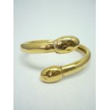 An 18ct gold open bangle, with oval terminals, 23g