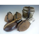 Four Second World War German water bottles and a set of mess tins with cutlery combination