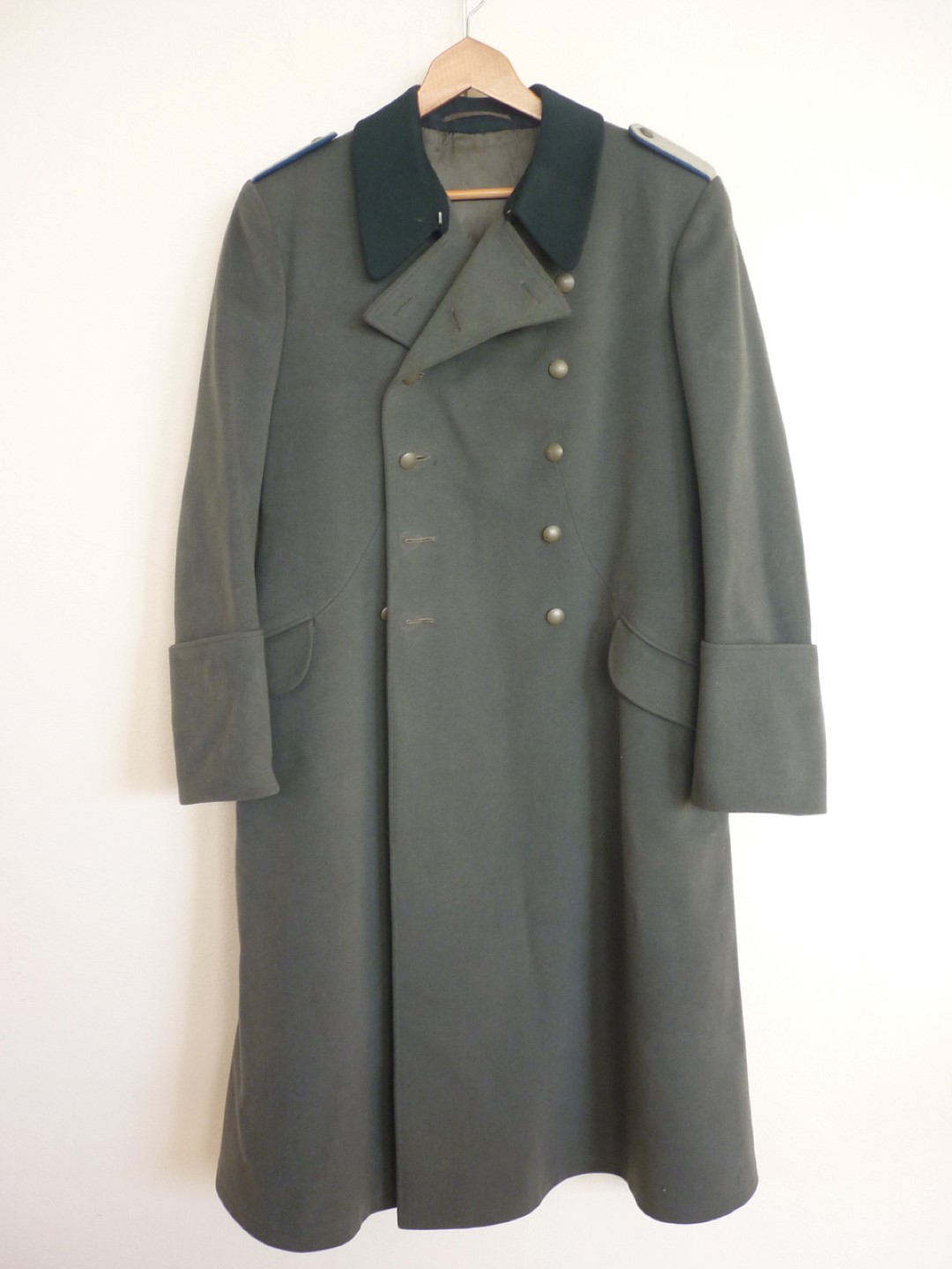 A Second World War German army officer's greatcoat with blue waffenfarbe