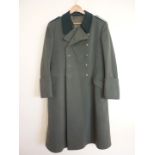 A Second World War German army officer's greatcoat with blue waffenfarbe