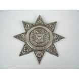 A Victorian silver association sash badge, in the form of an eight pointed foliate star, with