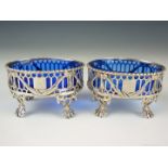 A pair of Victorian silver salts, of oval section and reticulated incorporating a central