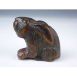 An Edo / Meiji Japanese carved hardwood katabori netsuke modelled as a rabbit