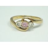 A 9ct gold, diamond and pink topaz dress ring, the three stones being both bezel and twist set