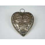 A Victorian silver heart-shaped paper clip, bass relief decorated in depiction of cherubim within