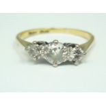 An early 20th Century three stone diamond ring, having three graded brilliants with the centre stone