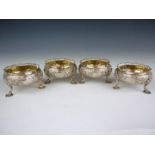 A set of four Victorian Rococo revival silver cauldron salts, each having floral chased and engraved