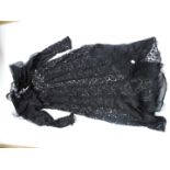 An early 20th Century lady's black lace evening dress, having hand pin-tucked panels and