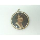 An Edwardian circular sentimental miniature portrait locket, the silver frame of channel-set paste