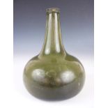 An early 18th Century green glass onion wine bottle