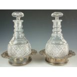 A pair of heavily cut Georgian style Prussian bodied decanters, together with a pair of mid 19th