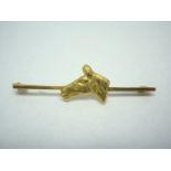 A mid 20th Century 9ct gold stock pin, the bar surmounted by the profile of a horse's head