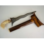 A Malayan kris with yellow metal mounted carved ivory stylized bird form hilt, wavy blade with