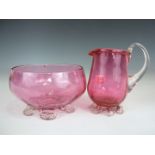 Two pieces of Victorian cranberry glass, comprising sugar bowl and cream jug, each having