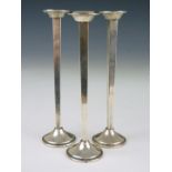 Three Cartier sterling silver solifleur vases, each of tapering square section with everted rim