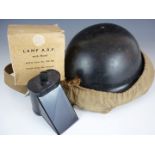 A Second World War Civil Defence 'Plasfort' helmet and canvas carrier, together with an ARP lamp