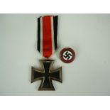 A German Third Reich Iron Cross second class together with an NSDAP party badge