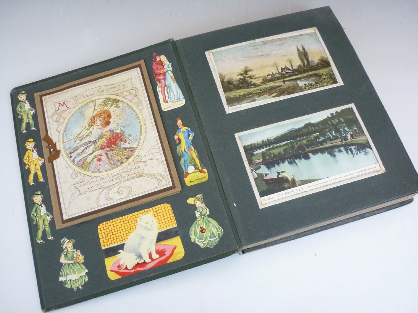 An early 20th Century photograph album containing approximately 96 postcards of a sentimental
