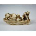 An Edo / Meiji Japanese carved ivory katabori netsuke modelled as a boatman labouring to transport a