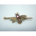 A Victorian split seed pearl, garnet and yellow metal novelty bumblebee bar brooch, the insect