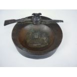 An early 20th Century German bronzed spelter dish modelled as a Garde du Corps helmet and rifle,